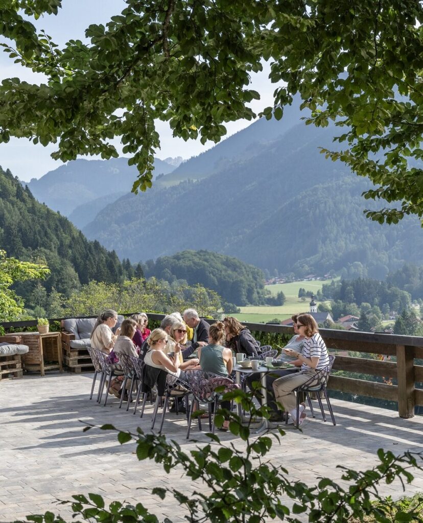 Yogagruppe isst auf der großen Terrasse mit Blick auf die Natur