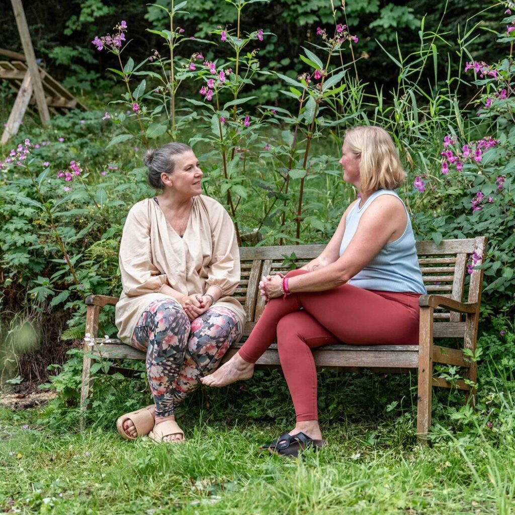 Gäste sitzen im Garten des Mountain Retreat Center im Gespräch